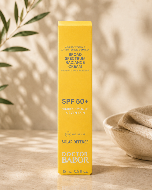 DOCTOR BABOR Solar Defense Broad Spectrum Radiance Cream SPF 50+ auf elegantem beigem Spa-Hintergrund – luxuriöse Anti-Aging Sonnenpflege mit UVA-, UVB-, HEV- und IR-Schutz für glatte und ebenmäßige Haut.